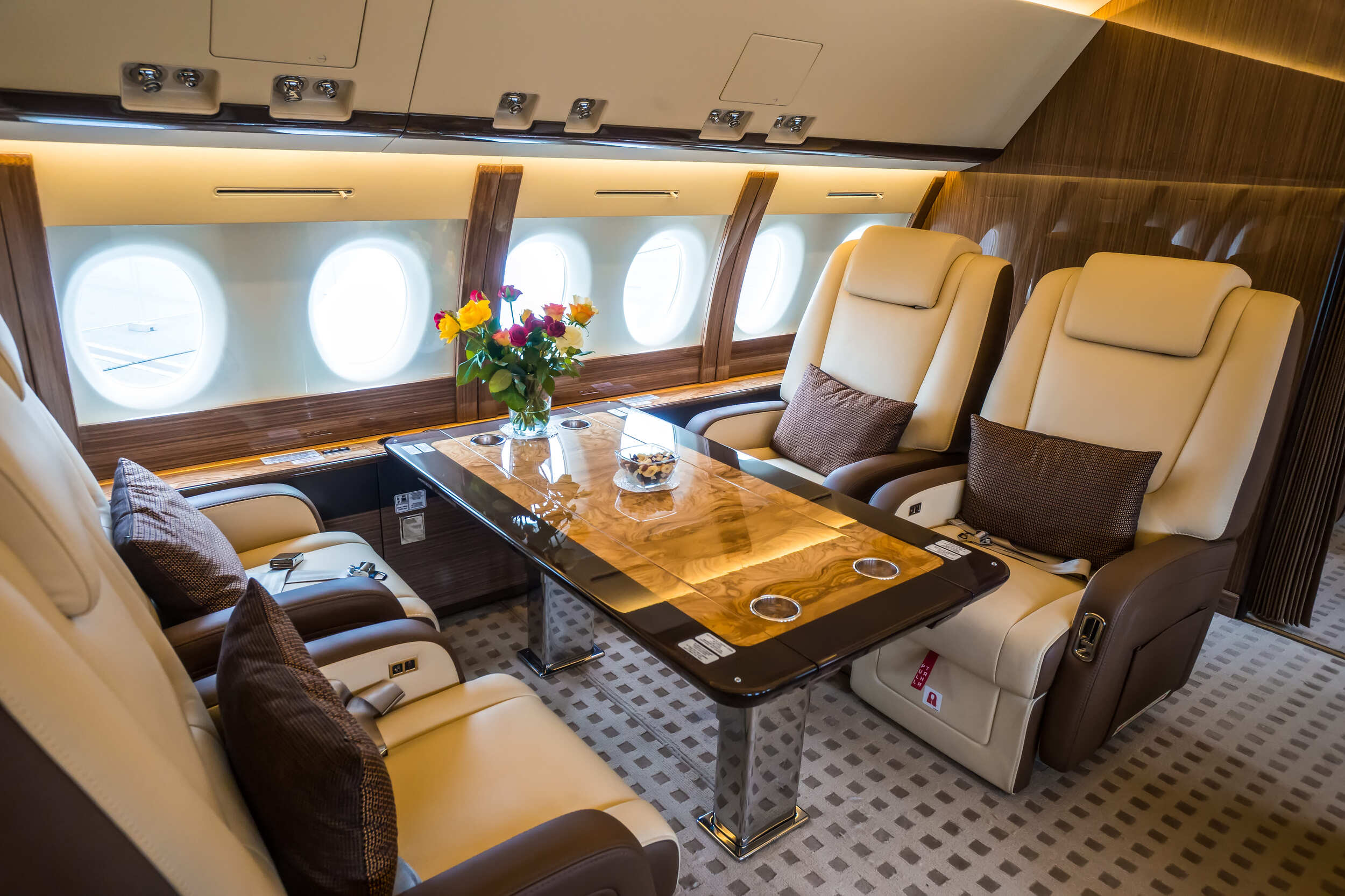 Private jet interior featuring luxurious leather seats arranged for comfort and elegance.