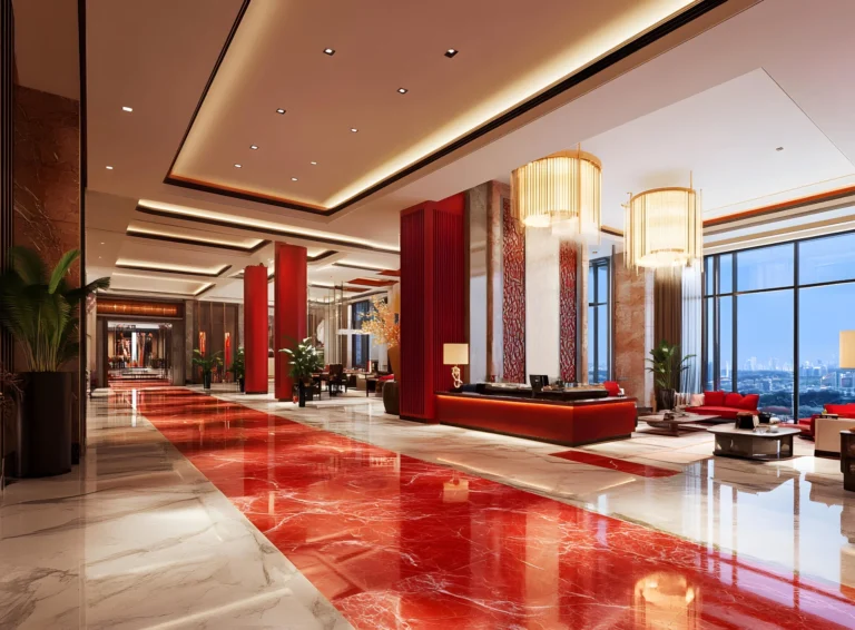 Luxurious hotel lobby with red and white marble floors, gold chandeliers, red columns, and large windows.